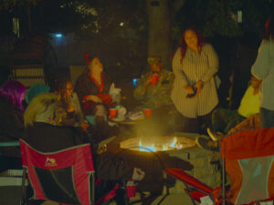 Vibrant picture of friends siting around the fire pit